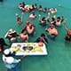 Group of people eating ceviche on a beach